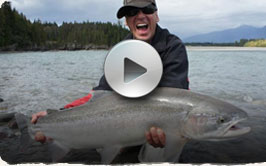 Picture of a smiling man holding a large Skeena River Steelhead